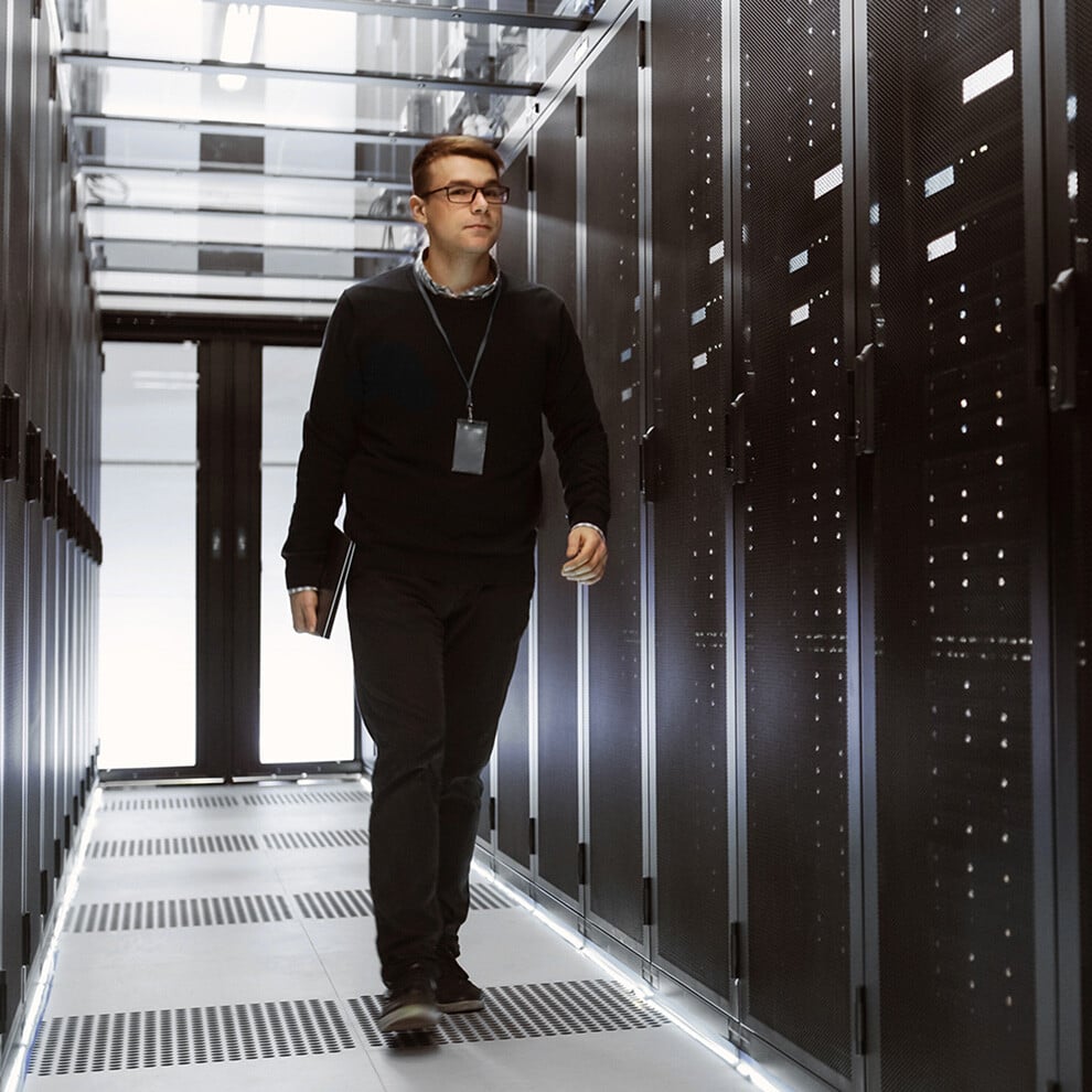 Photo of a Centersquare data center employee checking cabinets.