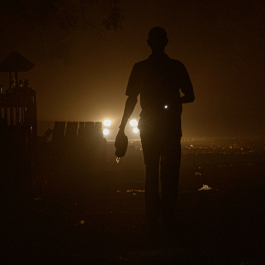 Image of a silhouetted person in a dark, power outage environment—symbolizing the urgency and resilience of disaster recovery and business continuity.